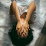 일상 속 스트레스, 새로운 관리법으로 가볍게 넘기기 a woman holds her hands over her face